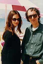 A woman and an older man, both wearing sunglasses