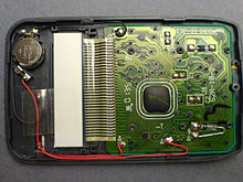 The interior of a pocket calculator. The dark lump of epoxy in the center covers the processor chip Citizen se-733 int 1ac.jpg