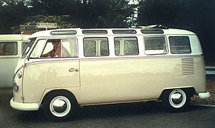 Un Volkswagen Combi Split Samba, capote de toit repliée, paré pour la route.