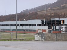 Headquarters in Potocari for soldiers under United Nations command; "Dutchbat" had 370 soldiers in Srebrenica during the massacre. The building was a disused battery factory. Dutchbat HQ 2009.jpg