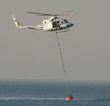 84 Squadron Bell Griffin HAR2 dips its bucket off the coast of Atlit, Israel during firefighting efforts on 3 December 2010 RAF-firefighters-Carmel-2010.jpg