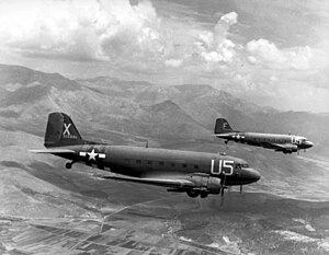 Two aircraft flying over mountainous terrain