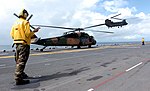 A S-70 Blackhawk and a CH-47 Chinook from the 5th Aviation Regiment operating from a United States Navy ship during an exercise in 2005