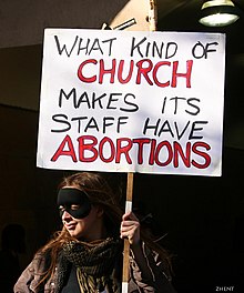 Protester against Scientology, holding a sign which reads: "What kind of church makes its staff have abortions" What kind of Church makes its staff have Abortions.jpg