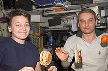 Astronauts making and eating hamburgers on board the ISS, 2002 AstronautsEatingBurgers.jpg