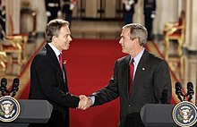 Shaking hands with then US president George W. Bush after their press conference in the East Room of the White House, November 2004 Blair Bush Whitehouse (2004-11-12).jpg