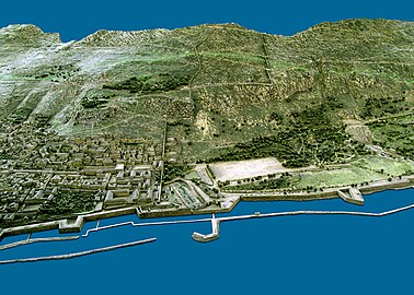 1865 model of Gibraltar from the west. The stepped structure of the upper King Charles V wall is to the right of center at the top. The lower portion, further to the left, runs straight up from the waterfront to the cliff.