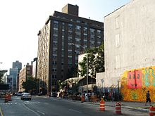 The 2010 recreation of Keith Haring's original 1982 mural; New York City's Bowery Mural wall at Houston Street and the Bowery Houston Street at the Bowery 2008.jpg