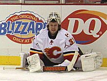 Ramo kneels by the boards as he stretches his lower body prior to a game.
