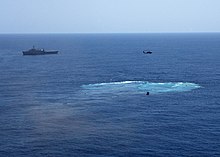 The wake left by America following her use as a live-fire target in 2005; the ship was used as a platform to test how the hull of large aircraft carriers would hold up against underwater attacks. Following the tests, America was scuttled, serving as a further test of the sinking of a large aircraft carrier. US Navy 050514-N-4374S-096 The decommissioned aircraft carrier, USS America (CV 66) was laid to rest after being sunk at sea.jpg