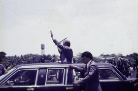 State visit of President Carter, waving from his car.