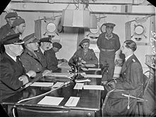 A scene on board HMS Bulldog during the first conference with Kapitanleutnant Zimmermann prior to the signing of the surrender document which liberated the Channel Islands on 9 May 1945. Left to right around the table are: Admiral Stuart (Royal Navy), Brigadier General A E Snow (Chief British Emissary), Captain H Herzmark (Intelligence Corps), Wing Commander Archie Steward (Royal Air Force), Lieutenant Colonel E A Stoneman, Major John Margeson, Colonel H R Power (all of the British Army) and Kapitanleutnant Zimmermann (German Kriegsmarine). Channel Islands Liberated- the End of German Occupation, Channel Islands, UK, 1945 D24595.jpg