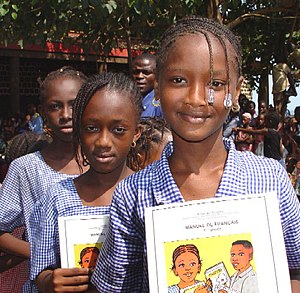 Schoolgirls with books donated by USAID in Con...