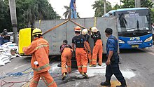 Indonesian fire fighters handling a traffic accident in Jakarta Indonesian fire fighters during a traffic accident.jpg