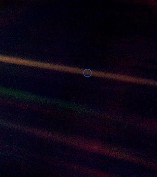 Pale blue dot image with a wider field of view to show more background.