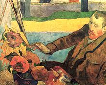 A seated red bearded man wearing a brown coat; facing to the left; with a paint brush in his right hand, is painting a picture of large sunflowers