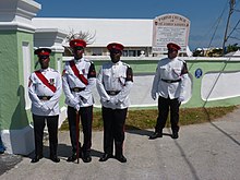 Regimental Police (with brassards) of the Royal Bermuda Regiment of the British Army in White No. 3 Warm Weather Ceremonial Dress. Royal Bermuda Regiment at St. James' Church in Somerset.jpg