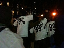 Protesters with the "99%" t-shirts at Occupy Wall Street on 17 November 2011 near the New York City Hall. We are the 99%25 t-shirts at Occupy Wall Street.JPG