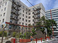 The Bok Sen (8 Immortals), 3 Wisdoms, and the Chinese Zodiac by Josie Grant is painted on the exterior of the lower level of West Ping Yuen, taken from Trenton Alley, facing north.