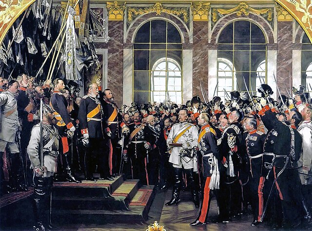 Прокламація Імператора Вільгельма I 18 січня 1871 в дзеркальній залі Версаля. У білому — прем'єр-міністр Пруссії Бісмарк. Картина Антона фон Вернера (1885)
