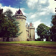 photo d'un château fort avec des arbres et une prairie