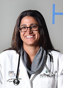 Dr. Hanna Attisha smiling in lab coat.jpg