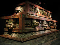 Restored partion of Teotihucan architecture showing the typical Mesoamerican use of red paint complemented on gold and jade decoration upon marble and granite.