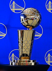 The Larry O'Brien Championship Trophy is awarded annually to the winning team of the NBA Finals, the league's championship series that concludes the playoffs. Golden State Warriors hold Hoops for Troops event at 129th Rescue Wing (10).jpg