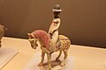 Woman rider wearing a tanling ruqun and a humao, Horse and female rider, Tang dynasty.[11]: 291 