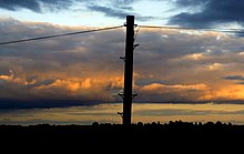 Broadband TV services are often distributed via copper telephone lines Telephone pole silhouette.jpeg