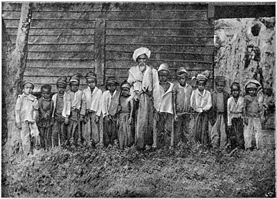 A TEACHER OF KURUʾAN-RECITAL WITH HIS PUPILS.