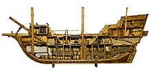 A bow to stern center cutaway showing an early sailing cargo ship.