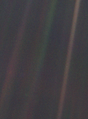 Image 6 Pale Blue Dot Photo cr: NASA/JPL "Pale Blue Dot" is the name given to this 1990 photo of Earth taken from Voyager 1 when its vantage point reached the edge of the Solar System, a distance of roughly 3.7 billion miles (6 billion kilometres). Earth can be seen as a blueish-white speck approximately halfway down the brown band to the right. The light band over Earth is an artifact of sunlight scattering in the camera's lens, resulting from the small angle between Earth and the Sun. Carl Sagan came up with the idea of turning the spacecraft around to take a composite image of the Solar System. Six years later, he reflected, "All of human history has happened on that tiny pixel, which is our only home." More selected pictures