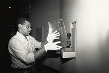 A specialist prepares an exhibit in 1987. Steve Smith installs an artifact.jpg