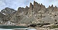 Cathedral Spires seen from Sky Pond. The apparent highest spire is "Saber" and immediately left of it is "Petit Grepon". At far left edge is Taylor Peak. Even though Sharkstooth is higher, it is hidden behind Saber.