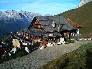 Die Friedrich-August-Hütte mit dem Val Duron und der Rosengartengruppe, in der Ferne die Rosszähne.