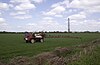 Farming activity at Carrington Moss, with the Shell facility in the background
