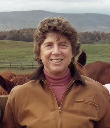 Helen Groves in 1984 standing in front of a paddock at her former ranch, Silverbrook Farms in Middlebrook, VA