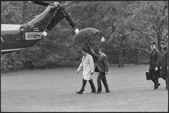 President Nixon walking to Marine One--he is being followed by a military aide carrying the nuclear football Richard M. Nixon walking out to Marine One in the rain - NARA - 194697.tif