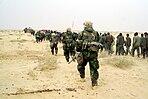 U.S. Marines with Iraqi POWs - March 21, 2003.jpg
