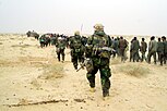 U.S. Marines with Iraqi POWs - March 21, 2003.jpg