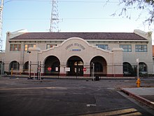front view of the southwestern architecture of the closed Union railroad station in Phoenix, surrounded by a chain link fence