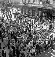 People in Athens celebrate the liberation from the Axis powers, October 1944. Postwar Greece would soon experience a civil war and political polarization. Athenaioi giortazoun ten apeleutherose tes poles tous, Oktobrios 1944.jpg