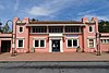 A two-story pink railroad station building