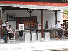 A polling station used for the 2014 Indonesian legislative elections. The four ballot boxes are at the front, while the voting booths are at the rear. IndonesianElection14voting.jpg