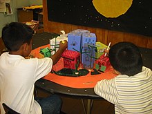 These 2nd graders from Buchanan Math Science Magnet School in Los Angeles, work on an art project. After studying the physical environment of the planet Mars, they are now designing a suitable Martian community. Magnet2.jpg