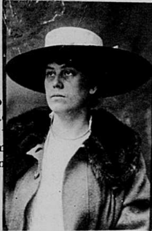 May Birkhead wearing a hat and looking away from the camera