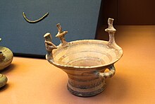 Mycenaean pottery basket with female figures around the rim