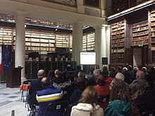 This image shows an audience attending a public lecture at a library.