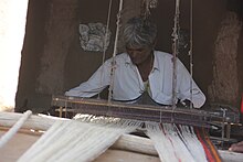 Weaver weaving Pattu on pit loom